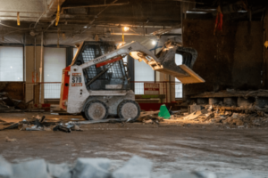Demolition skid steer hauling concrete
